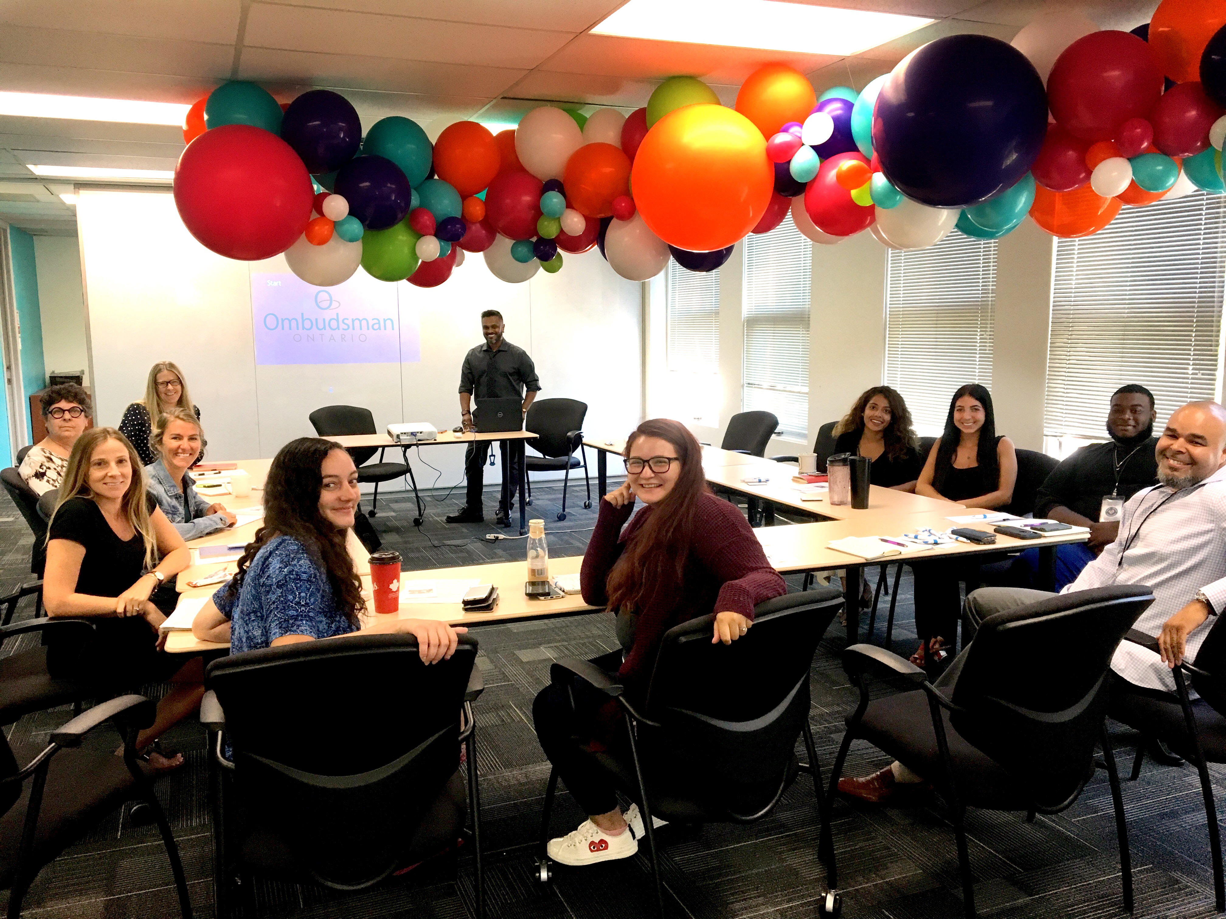 Children and Youth Unit staff present to representatives from a foster care agency, at the agency's office.